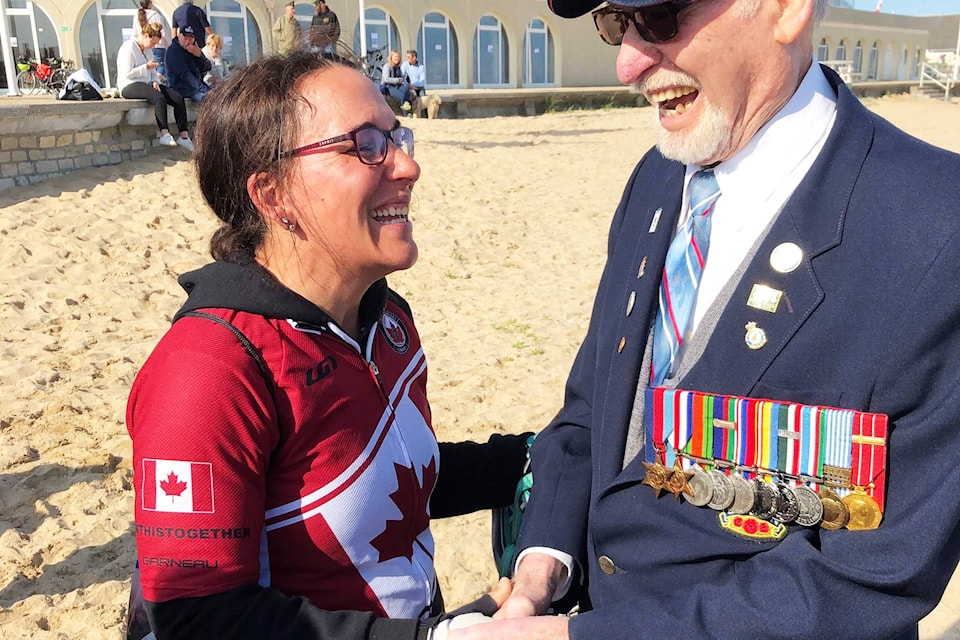 Lindsay Chung shares a moment with D-Day veteran Russ Kaye on Juno Beach June 6 during the final day of the Wounded Warriors Canada Battlefield Bike Ride. This was the first time Kaye stepped onto the beach since he landed here as a 20-year-old gunner with the 43rd Battery E Troop 12 Field Regiment 75 years ago. Kaye accompanied the Battlefield Bike Ride cyclists to various significant sites in Normandy over seven days as they travelled from Dieppe to Juno Beach, and he waited at the beach until the whole group was together before walking onto the sand in front of Canada House. Photo courtesy of Mike Spellen