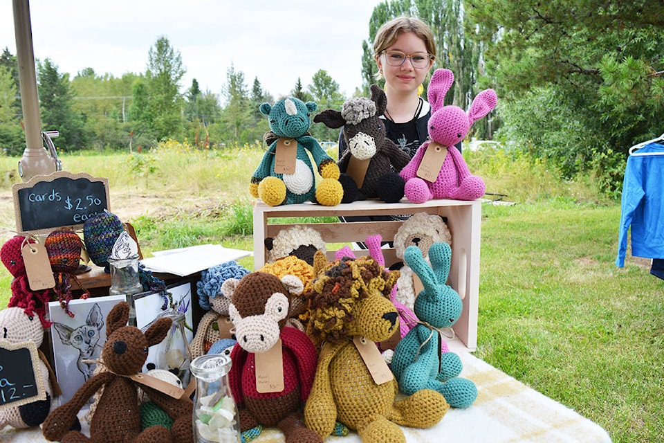 Olivia Collins helps sell knitted animals, sea glass mobiles and cards at the EdgeWood Farm Acre Long Antique and Artisan Market. Lindsay Chung photo