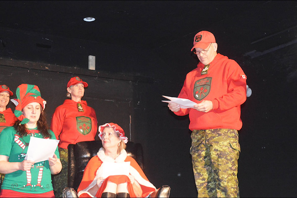 Sgt. Paul Nichols presents the 4th Canadian Rangers Patrol Group B.C. Company Quesnel Patrol to Mrs. Claus, their honorary colonel, in the Kersley Players’ Christmas play, “Hark! The Herald Rangers Sing!.” The play was part of the Kersley Community Annual Christmas Party, held Dec. 21 at the Kersley Community Hall. (Lindsay Chung - Quesnel Cariboo Observer)