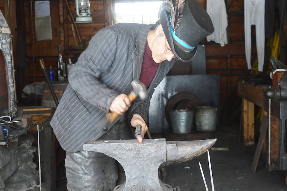Making bottle openers at the Cameron and Ames Blacksmith Shop Monday, Feb. 17 during Family Weekend Celebrations at Barkerville Historic Town and Park. (Lindsay Chung - Quesnel Cariboo Observer)