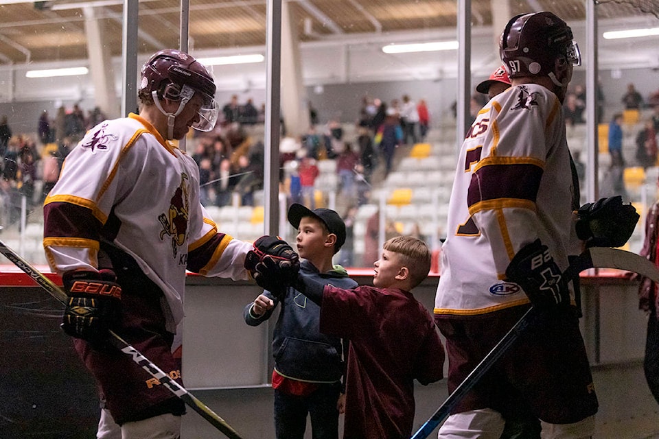 A couple of young Quesnel Kangaroos fans get fist-bumps from their heroes as they head into the locker room after beating the Terrace River Kings 8-4 on Feb 29. (Sasha Sefter - Quesnel Cariboo Observer)