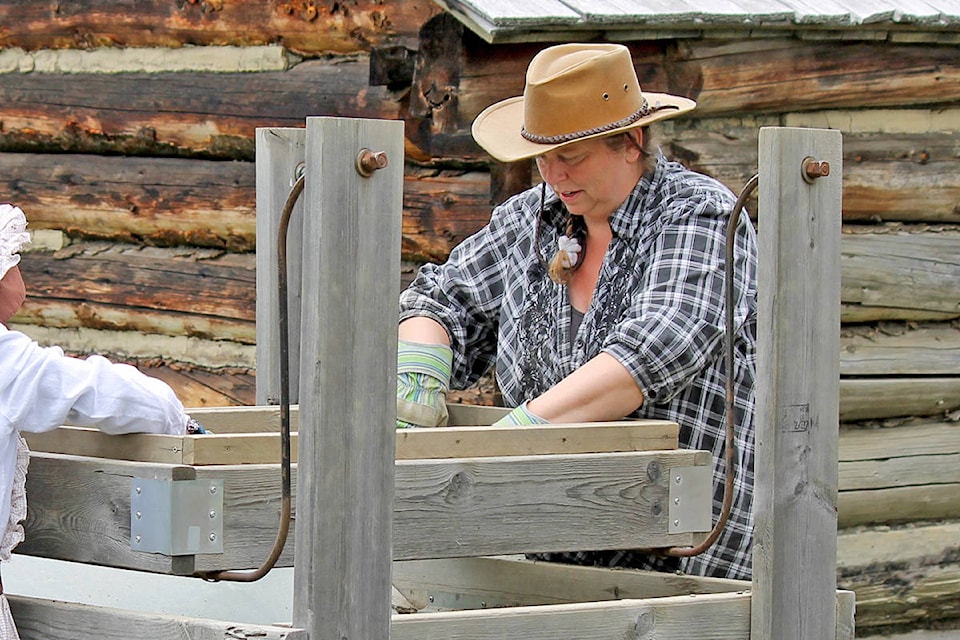Barkerville Historic Town and Park archaeologist Dawn Ainsley searches through a screen with a visiting student near a dig site. Ainsley studies relics of the past, including artifacts from some 2,000 Chinese miners who lived in the area during the Gold Rush. (Photo submitted)