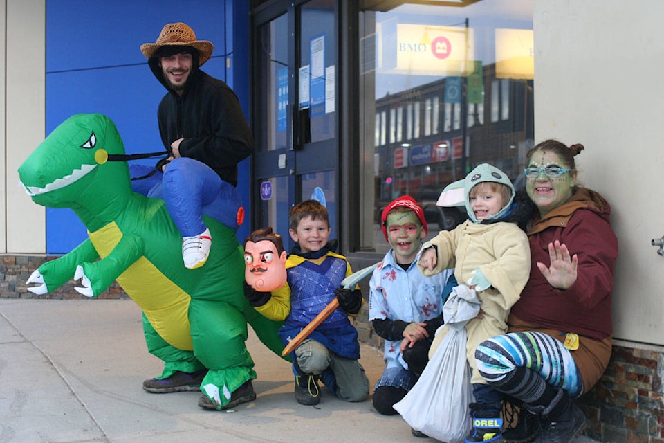 Auntie Beth, Jarret Campbell, Bodin Favel, Ethan James and Eric Campbell got into the spirit of Halloween while visiting businesses on Reid Street Saturday, Oct. 31. Fewer businesses than usual handed out candy because of the pandemic. (Cassidy Dankochik Photo - Quesnel Cariboo Observer)