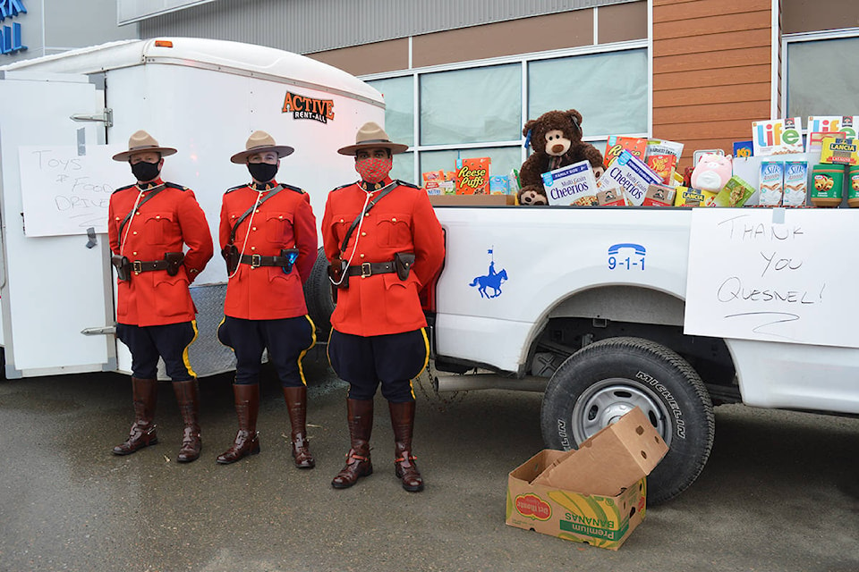 From left, Quesnel RCMP members Const. Matt McGregor, Const. David Judge and Const. Jaylan Hundial accept donations at the RCMP’s Stuff a Cruiser fundraising event Saturday, Dec. 5 at the West Park Mall. (Lindsay Chung Photo - Quesnel Cariboo Observer)