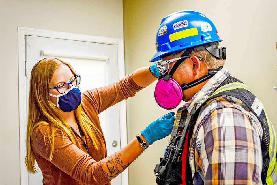 Haley Ramier, loss prevention summer student at Gibraltar Mines Ltd., left, fit tests the respiratory mask of Rod Randel, general forman, mill ectrical. (Gabrielle Pierce Photo)