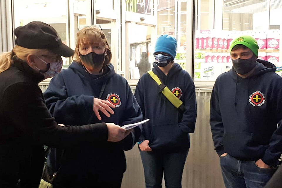 Central Cariboo Search and Rescue members briefly go over grocery lists outside Save-On-Foods before heading inside where they would spend more than one-hour shopping for on-reserve Yunesit’in households. (Rebecca Dyok photo)