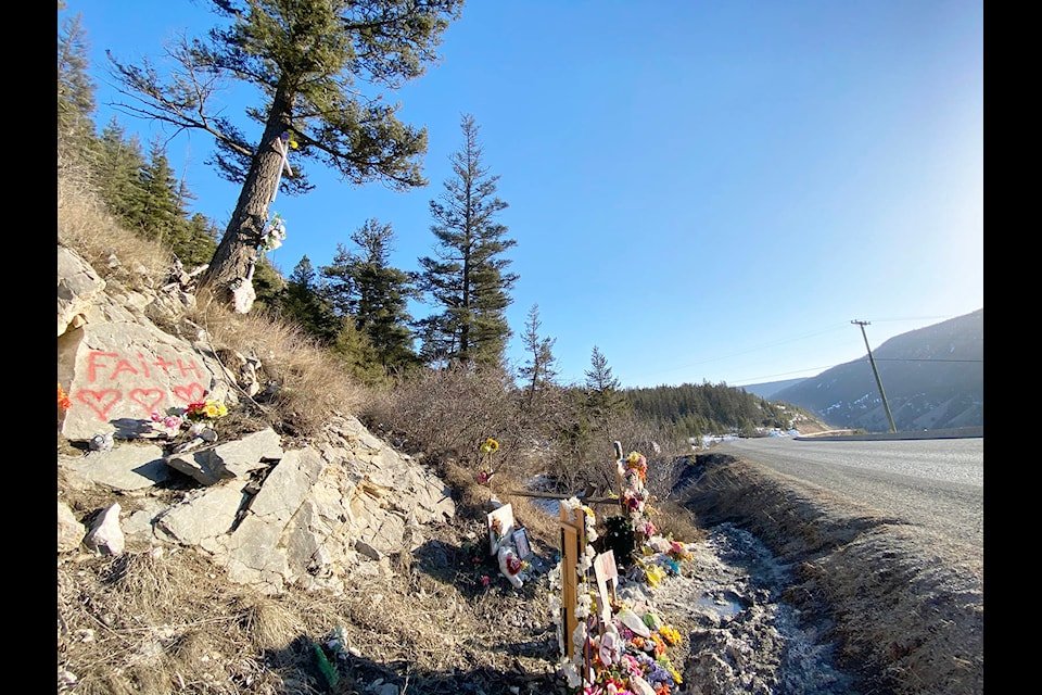 Photographs, cards, flowers and a cross mark the location along Highway 20 where a single vehicle crash Oct. 19, 2019 claimed the lives of two Williams Lake teens and injured three others. (Angie Mindus photo - Williams Lake Tribune)