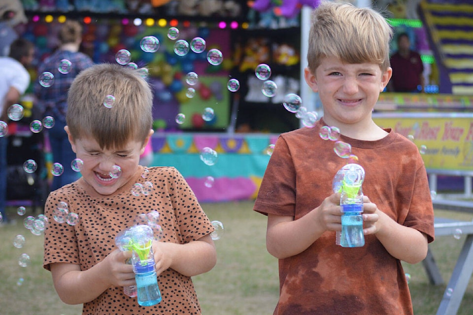 Jayce and Cache Dollman show off the bubble sprayers they won as prizes at the West Coast Amusements Fair which rolled into Quesnel from Sept. 3 - 5. (Cassidy Dankochik Photo - Quesnel Cariboo Observer)