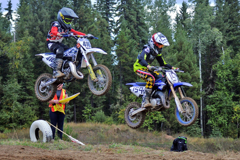 Jake McGaw (416) and Simon Pastor (159) go head to head in the air during the 65cc Open race at the Quesnel Motocross Track. (Cassidy Dankochik Photo - Quesnel Cariboo Observer)