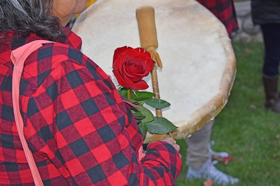 Young men handed out flowers to women at Boitanio Park in Williams Lake on Monday, Oct.4. (Rebecca Dyok photo)