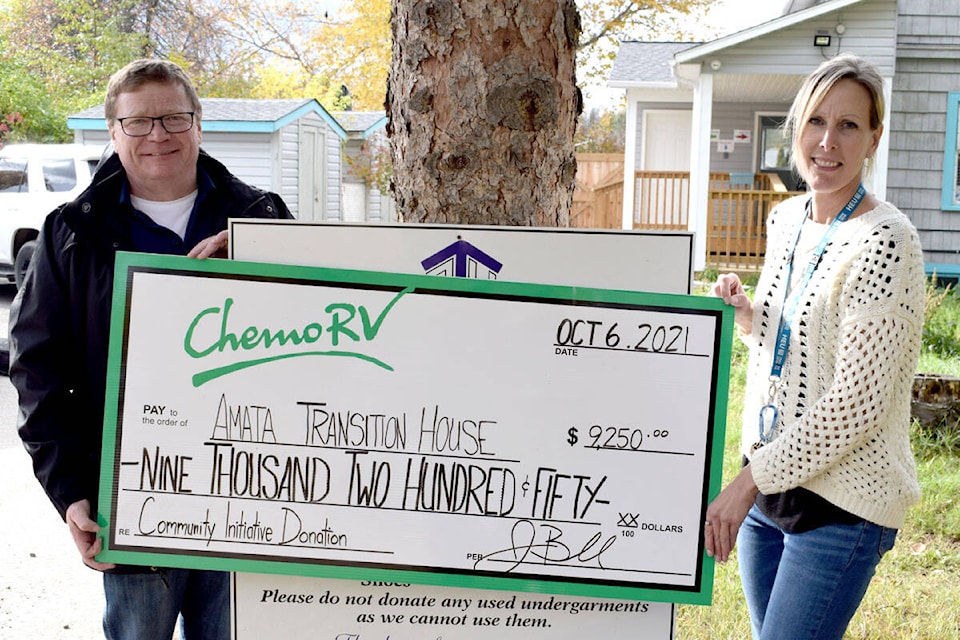 Amata Transition House residence co-ordinator Angela Neufled accepts a cheque from Chemo RV manager Steve Rutledge. (Tracey Roberts Photo - Quesnel Cariboo Observer)