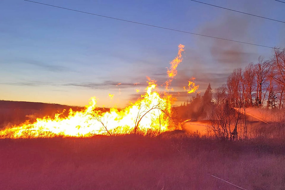 Windy conditions challenged firefighters on scene of a blaze at a West Fraser log yard in Quesnel late Tuesday, afternoon Nov. 9. (Cassidy Dankochik photo)