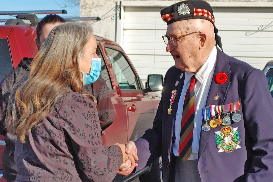 William (Bill Stevens) shakes the hand of a community member who came to honour him on Remembrance Day. For some this was their first time meeting Stevens who they wanted to thank for his service. (Rebecca Dyok photo)