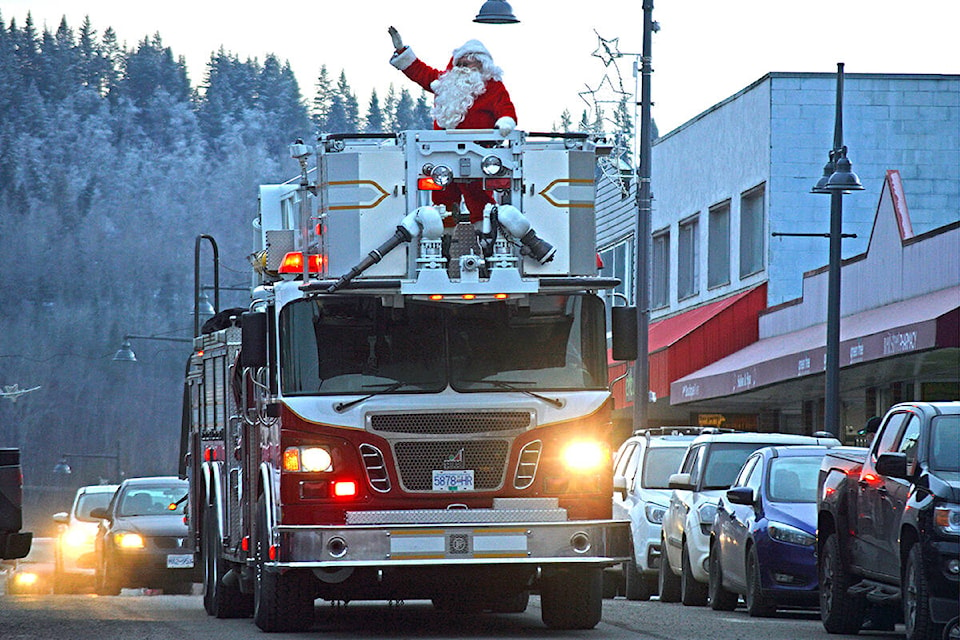 Santa took time from his busy schedule preparing for Christmas Eve to make a surprise visit in downtown Quesnel on Saturday, Dec. 4. Transportation for the VIP was provided by the Quesnel Volunteer Fire Department. Other activities marking his arrival included street hockey, photos and fireworks. For more, check out page 10 of the Quesnel Cariboo Observer. (Rebecca Dyok photo - Quesnel Cariboo Observer)