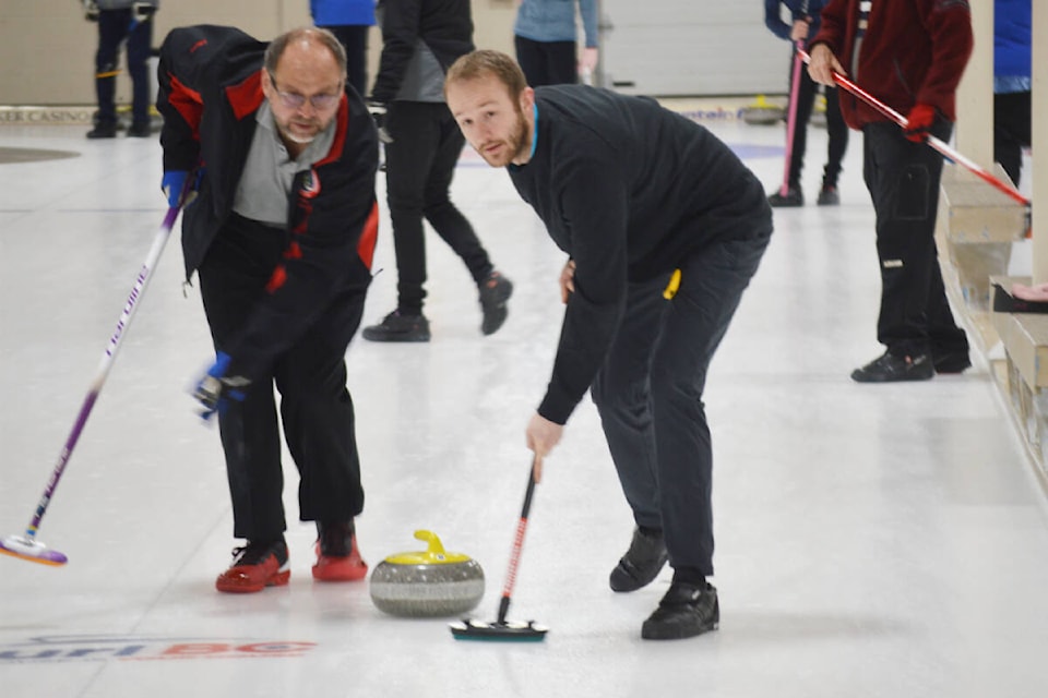 Two players look for instruction from their skip while playing in the Mixed Bonspiel in Quesnel on Sunday, Feb. 20. (Cassidy Dankochik Photo - Quesnel Cariboo Observer)