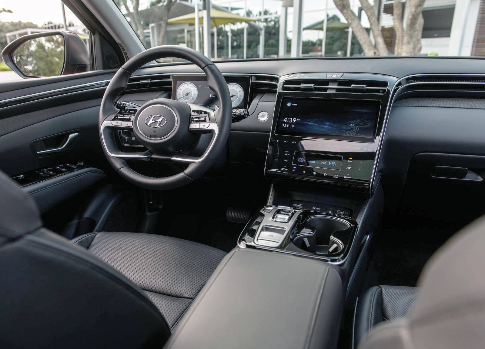 The 2022 Tucsons dash takes a whole new direction. Theres a shiny interface, digital gauges popping out behind the steering wheel, and a small pad of buttons that replaces the traditional transmission shift lever. PHOTO: HYUNDAI