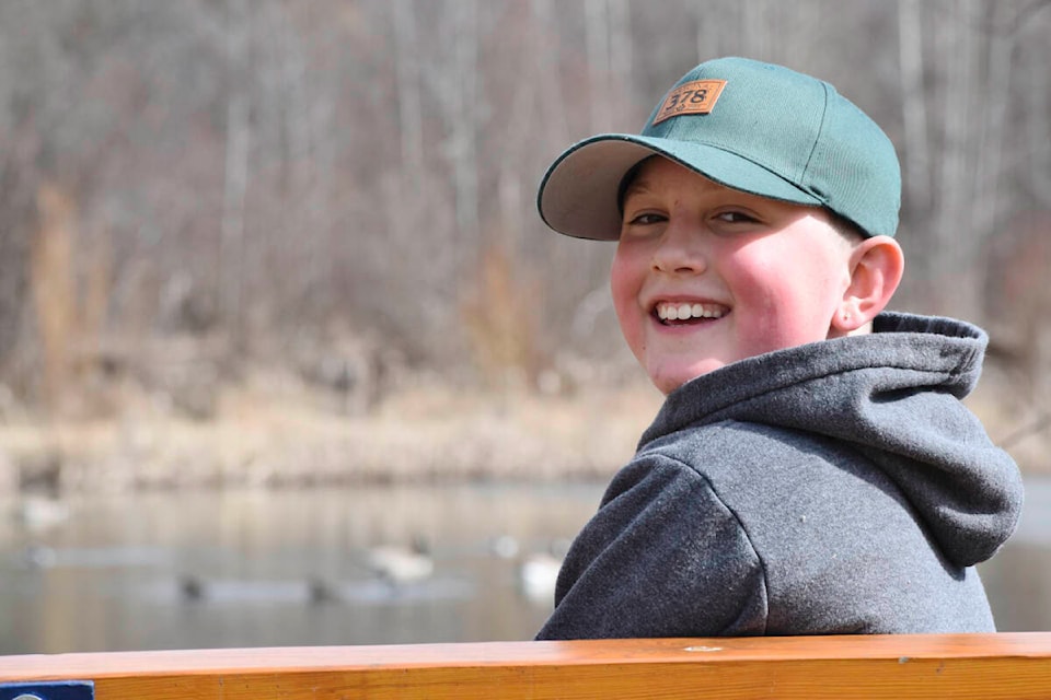 Karson Moores couldn’t hide his happiness at West Fraser Timber Park on Saturday, April 2 where he watched ducks and geese swim in a pond. (Rebecca Dyok photo — Quesnel Cariboo Observer)