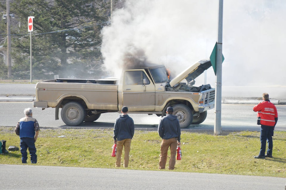 Quesnel fire chief Ron Richert radios for backup after arriving on the scene in the command truck. Bystanders tried to knock the fire with handheld extinguishers, and appeared to stall the fire’s spread. (Cassidy Dankochik Photo - Quesnel Cariboo Observer)