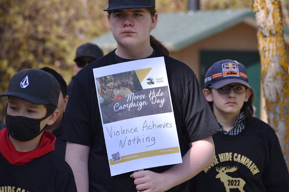 Many young men held signs in Quesnel where they pledged against violence of women and children Thursday, May 10. (Rebecca Dyok photo — Quesnel Cariboo Observer)