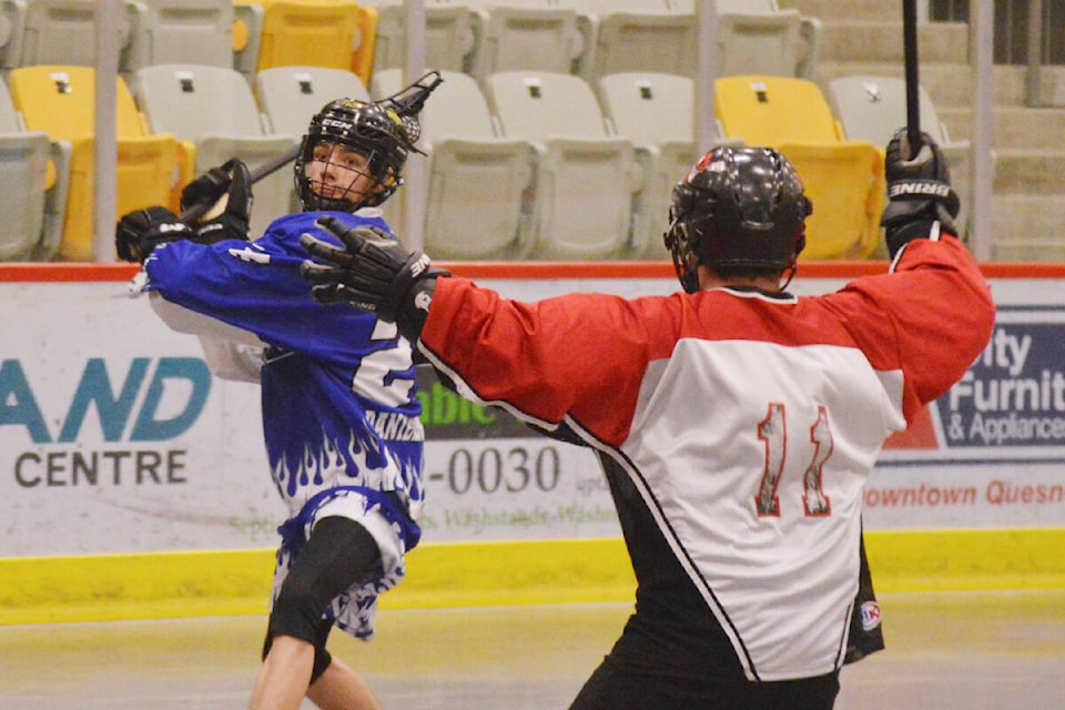 A Quesnel Crossfire player looks to shoot while the Bandits’ Drew Doig looks to block the path to the net. (Cassidy Dankochik Photo - Quesnel Cariboo Observer)