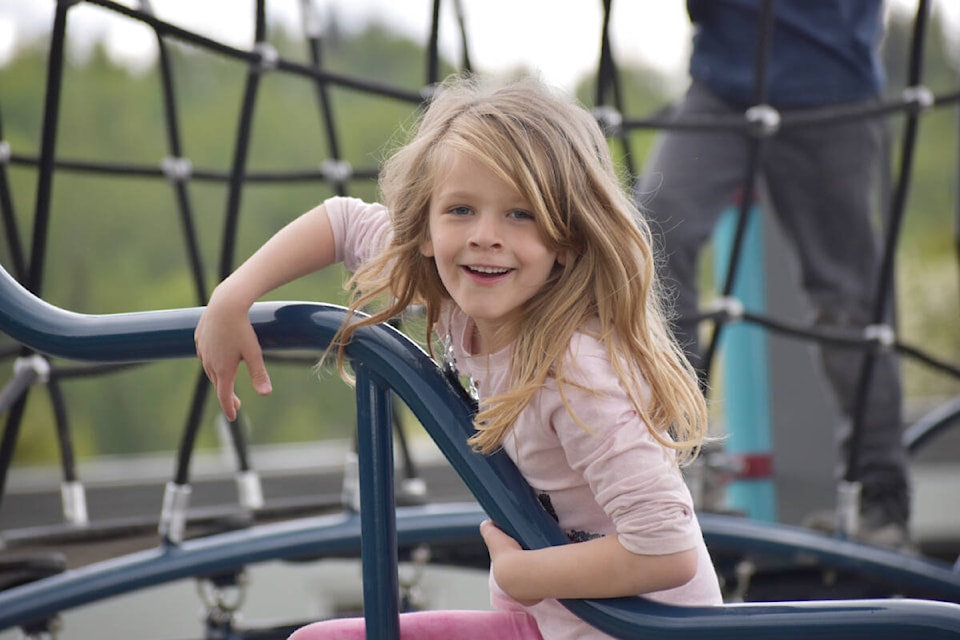Carson Elementary kindergartener Haelyn Aiken plays on the new playground Wednesday, May 25. (Rebecca Dyok photo — Quesnel Observer)