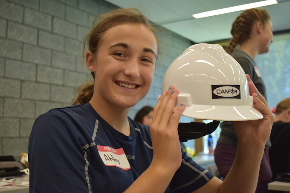 Abbey Mackay, 11, holds up her hard hat. (Rebecca Dyok photo — Quesnel Observer)