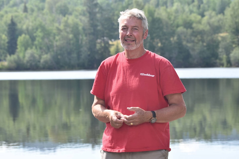 Bouchie Lake Watershed Stewardship Society director David Law stands in front of Milburn Lake following the Dam Beaver Poker Paddle on Saturday, Aug. 20. (Rebecca Dyok photo — Quesnel Observer)