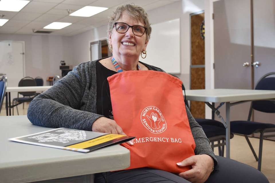 Linda Veer took home an emergency bag after hearing from Quesnel Emergency Support Services (ESS) volunteer Jennifer Pinette. (Rebecca Dyok photo — Quesnel Observer)
