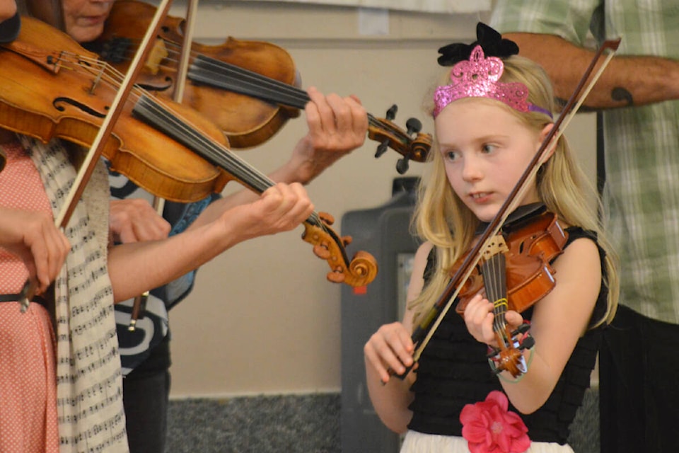 Theda Lakey, 9, plays the fiddle Saturday, Oct. 1 at the Quesnel Royal Canadian Legion. Lakey, the first fiddle player in her family, took home first place in the little britches (little junior) category. (Rebecca Dyok photo — Quesnel Observer)