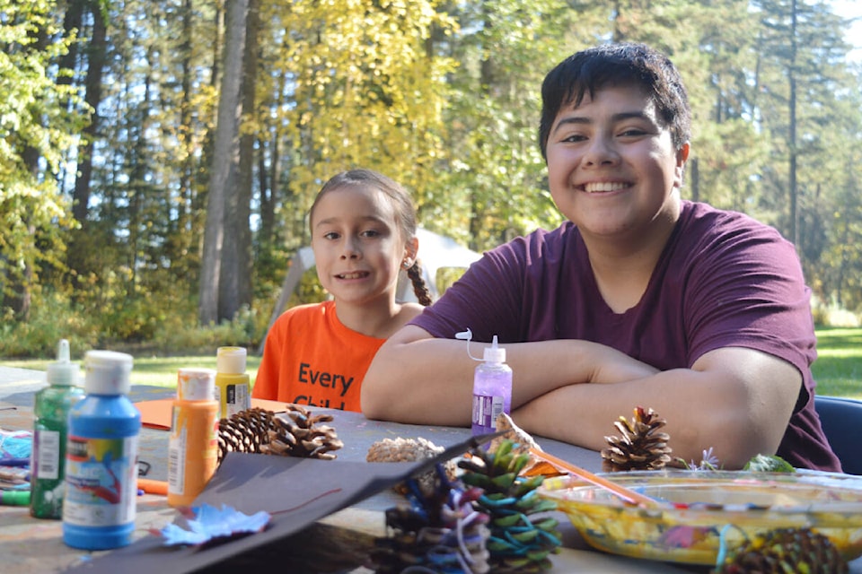 Siblings Esmae LeMarellec (left) and Phoenix Harding made Thanksgiving cards from materials collected during a walk in the forest. (Rebecca Dyok photo — Quesnel Observer)