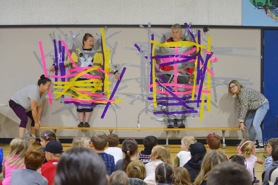 Principal Corry Climenhage (left) and teacher Don Schneider were duct taped to the wall on Friday, Oct. 14 in front of students. (Rebecca Dyok photo — Quesnel Observer)