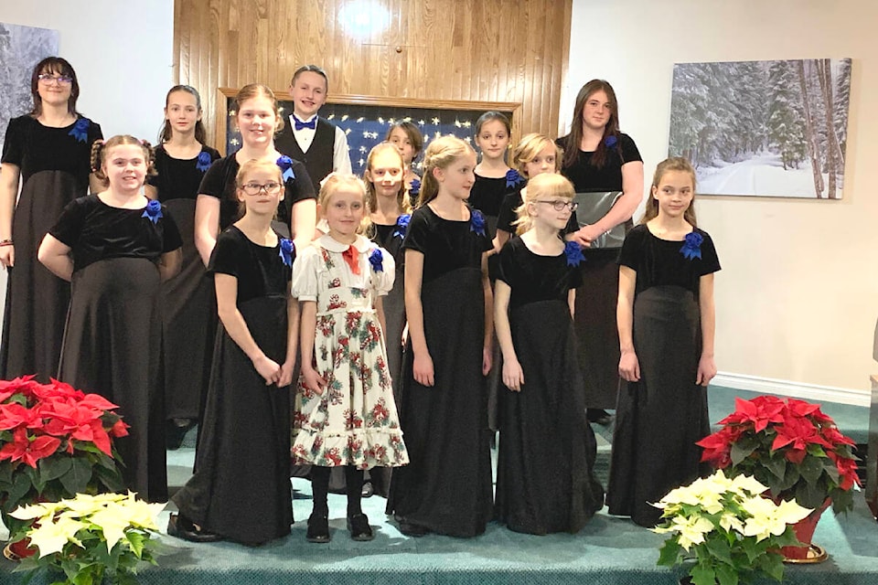 The Colors of Christmas with InSong, with Hannah Lewis (far left at back) and Olivia Williams ( far back right), raised $1,250 for the Anglican Church’s Community programs and $1,270 for the Seventh Day Adventist Church’s Bags of Love Program recently. (Tracey Roberts photo)