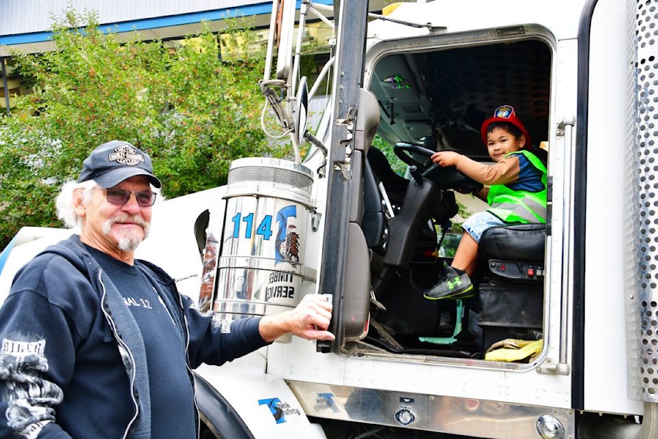 Little logging truck driver Angelo Mendoza gets some pointers from slightly more veteran driver Colin Lawson during the Quesnel Child Development Centre’s annual Touch A Truck event. (Karen Powell photo - Quesnel Cariboo Observer)