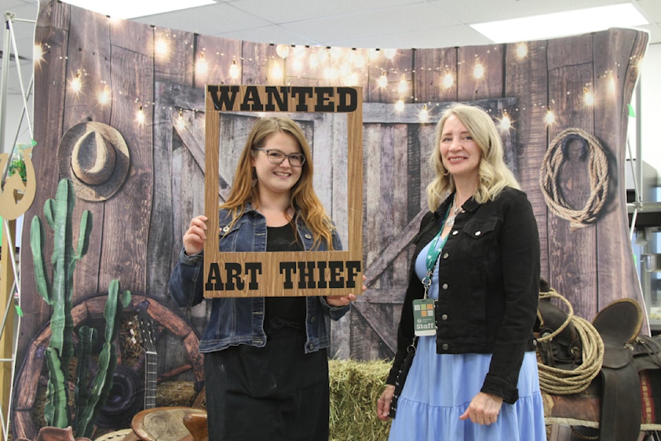 Kaitlyn Buckland, daughter of Paint of Interest owner Shelly Buckland, poses for a photo with Westerner Park CEO Shelly Flint at Paint of Interest on Tuesday. (Photo by Sean McIntosh/Advocate staff)