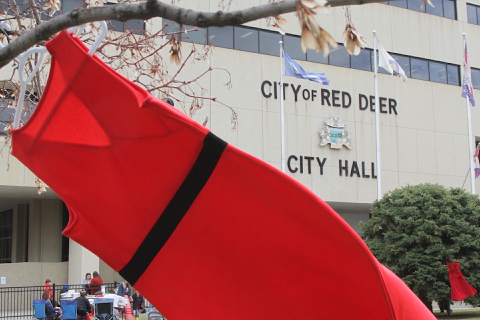 A red dress blows in the wind in front of Red Deer City Hall. A pair of events were held for Red Deerians to mark Red Dress Day this past Sunday. (Photo by Sean McIntosh/Advocate staff)