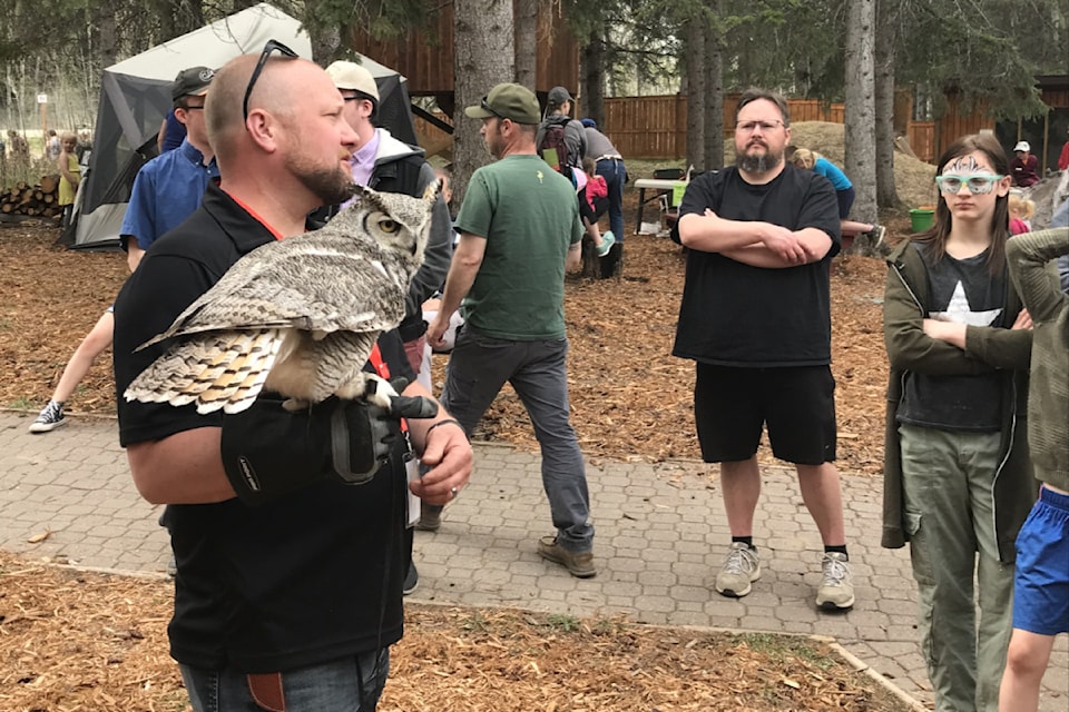 Todd Kelly with Otis the Owl during Medicine River Wildlife Centre's 40th anniversary celebration on Saturday. (Photo by Paul Cowley/Advocate staff)