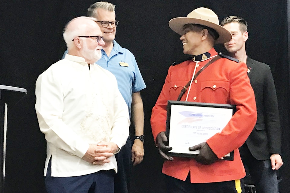 Filipino-Canadian RCMP officer Const. Julius Abreu, who works out of Blackfalds detachment, accepts a Certificate of Appreciation from Mayor Ken Johnston at a Philippines Independence Day event in Red Deer on Wednesday. City councillors Bruce Buruma (back left) and Chad Krahn look on. (Photo by Paul Cowley/ Advocate staff)