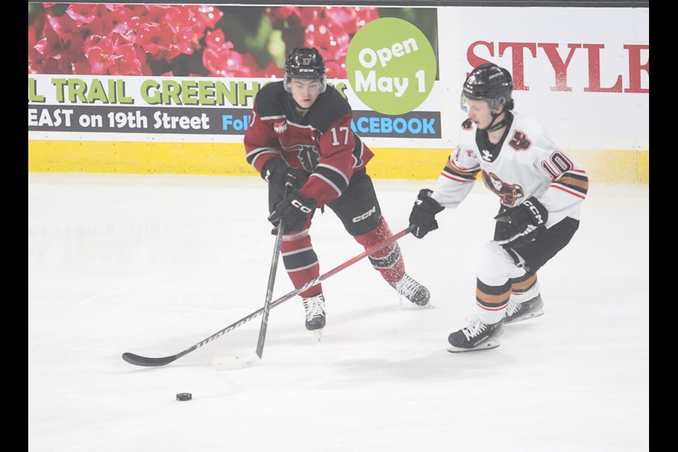 Red Deer Rebels captain Ollie Josephson battles for the puck in the neutral zone against the Calgary Hitmen on Saturday night at the Peavey Mart Centrium.
