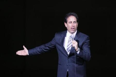 Comedian Jerry Seinfeld is seen on stage while he performs at a benefit concert for 'Autism Speaks' in New York