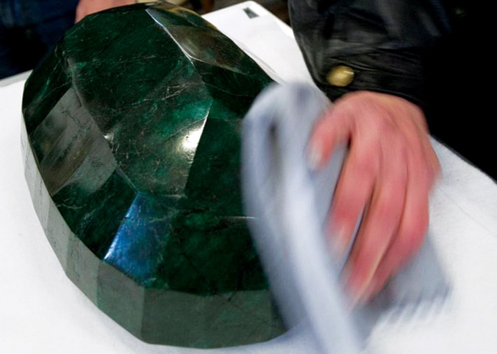 A worker polishes the world's largest emerald at Western Star Auction House in Kelowna