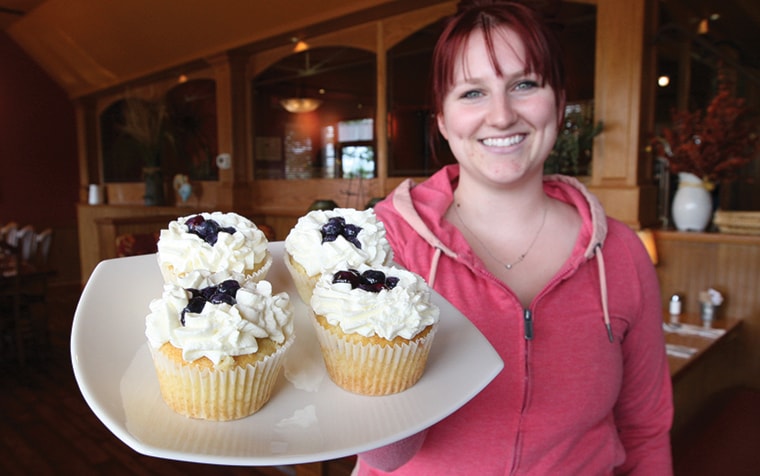 Natalie Leclair of La Cupcakerie holds a plate of her creations.