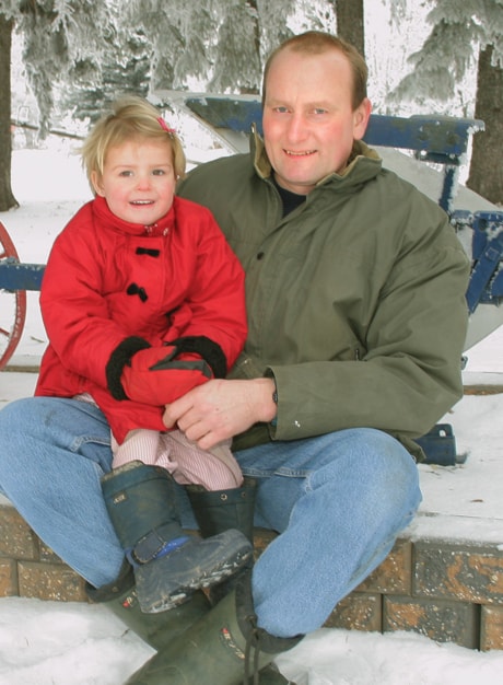 Arnold Van Ginkel and daughter Lydia, 3, on their farm near Leslieveille.