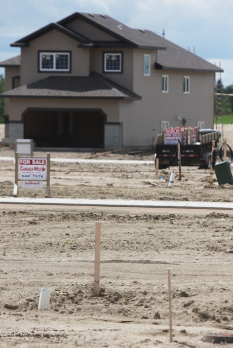 New homes in the community of Sunnybrook South are pictured next to empty lots.