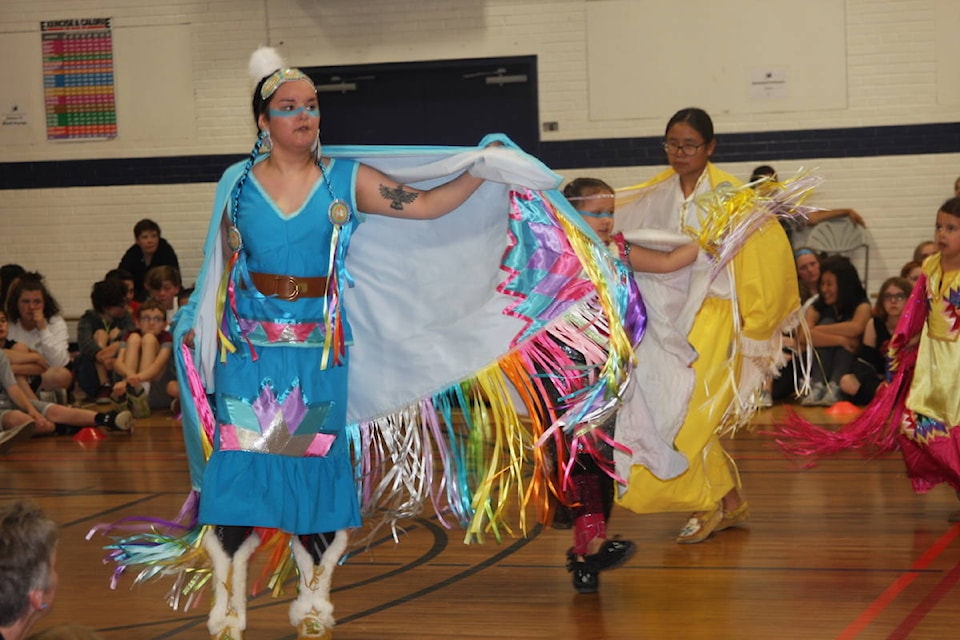 Heidi Coltman leads a row of fancy dancers at a powwow Monday at Eastview Middle School (photo by LANA MICHELIN/Advocate staff).