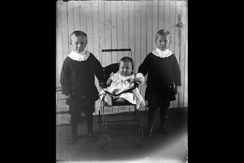 Group portrait of the children of Nils and Regina Soderberg of the Burnt Lake district near Red Deer, Alberta. From left to right: Helge Soderberg; Sadie Soderberg; Ingve Soderberg. Note the Swedish outfits worn by the boys.