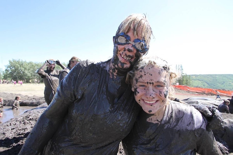 Barb Jackson and Raegan Blatchford of Sundre were all muddy smiles as they approached the finish line at the Mud Hero event at Canyon Ski Resort on Saturday. The annual event drew thousands of participants to Central Alberta and featured a 10 km course with 25 obstacles to negotiate. See related video at reddeeradvocate.com (Photo by Jeff Stokoe/Advocate staff)
