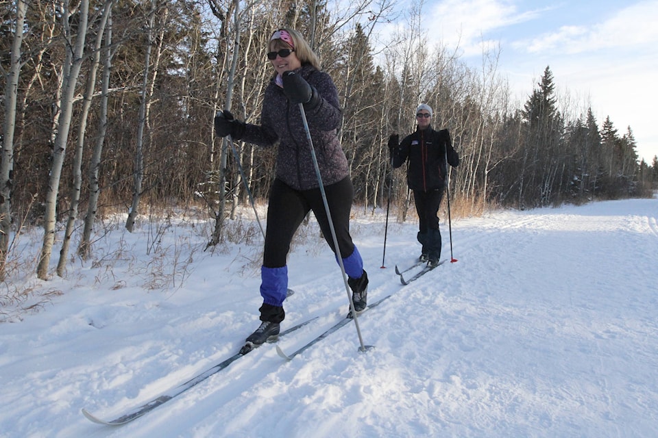 Red Deer’s Sue and Don Batchelor enjoy the winter weather Thursday by cross-country skiing through Heritage Ranch. (Photo by Sean McIntosh/Advocate staff)
