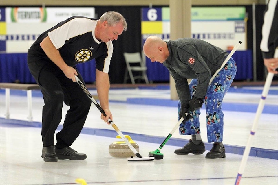 Rod Craven and Ed Burton competing in the 36th annual Red Deer Oilmen’s Bonspiel at the Pidherney Curling Centre Saturday. The bonspiel wraps up Sunday. (Photo by SEAN MCINTOSH/Advocate staff)