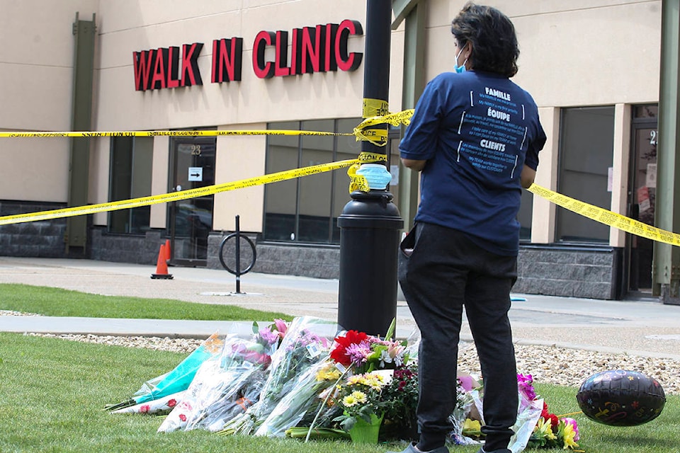 Photo by BYRON HACKETT/Advocate staff Reshmi Lata, whose son was a patient of Dr. Walter Reynolds, shows her respects Tuesday at a memorial outside the Village Mall Walk-In Clinic. A 54-year-old Red Deer man is charged in connection with the doctor’s death.