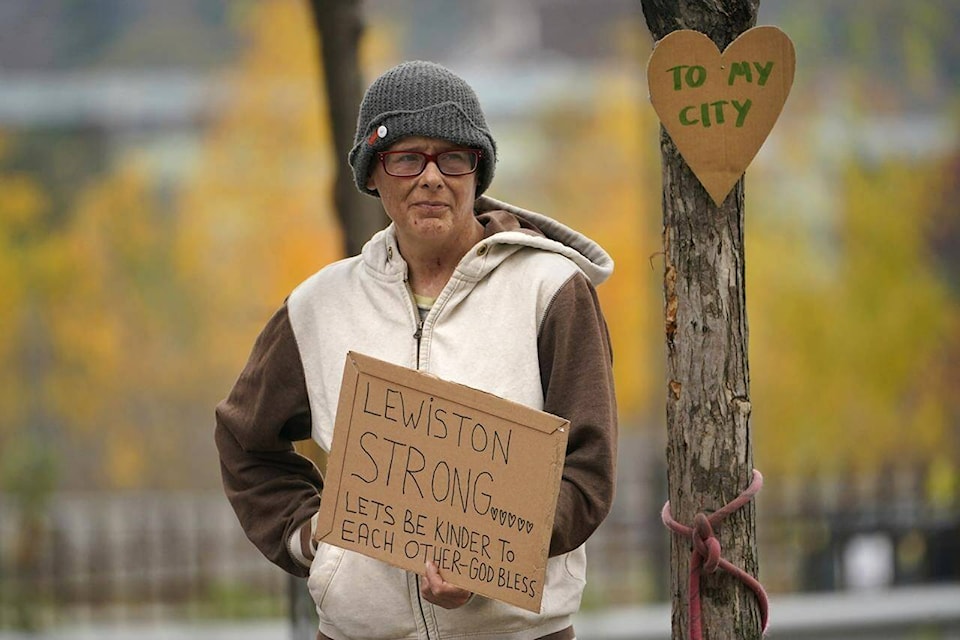 Jess Paquette expresses her support for her city in the wake of Wednesday’s mass shootings at a restaurant and bowling alley, Thursday, Oct. 26, 2023, in Lewiston, Maine. Police continue their manhunt for the suspect. Authorities urged residents to lock themselves in their homes and schools announced closures on Thursday. (AP Photo/Robert F. Bukaty)